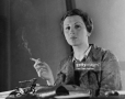 portrait-of-german-photographer-gerda-taro-as-she-smokes-a-cigarette-seated-behind-a.jpg